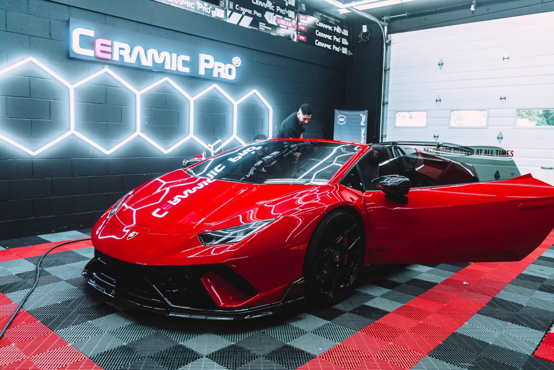 Red Lamborghini inside the PROGUYS Ceramic Pro service bay