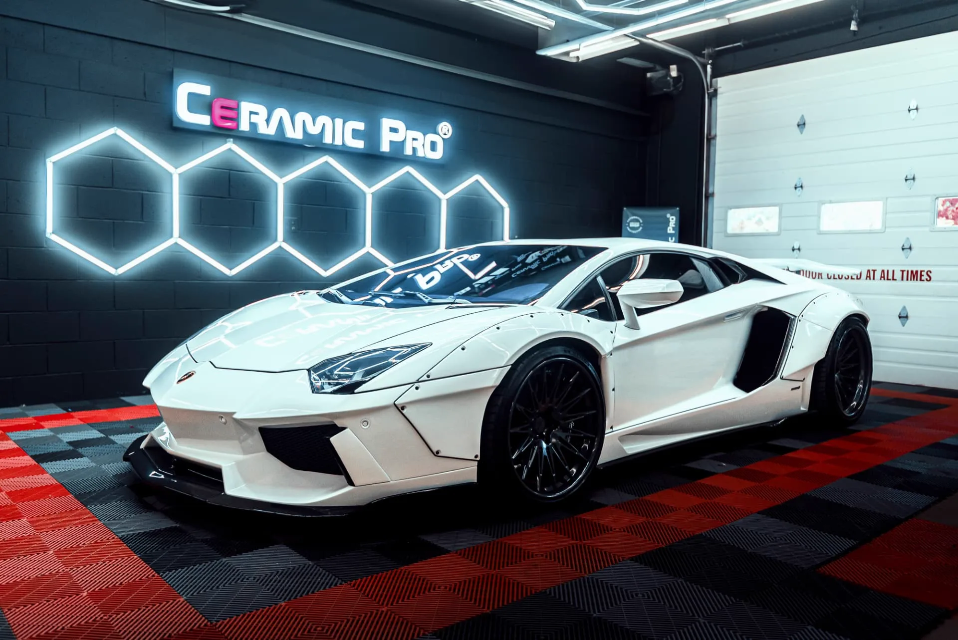 White Lamborghini inside the PROGUYS Ceramic Pro service bay