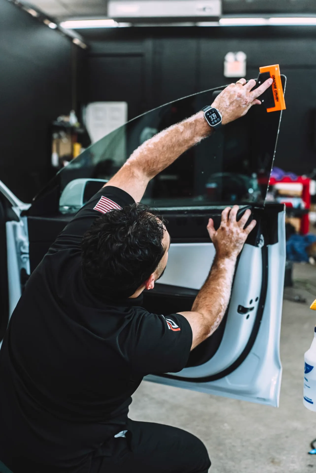 PROGUYS technician applying window film with a squeegee